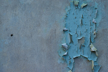 The old cement wall that the paint has dropped.