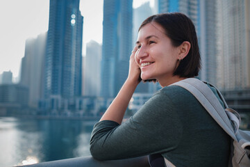 Fototapeta premium Happy young female traveler in the big city of Dubai, UAE
