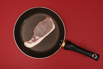 raw bacon in a frying pan