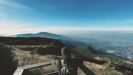Fototapeta premium young man Thai boy Asian hipster men backpacker enjoying on beautiful landscape scenery view jungle mountains forest at Kew Mae Pan Nature Trail Doi Inthanon National Park, Chiang Mai, Thailand.