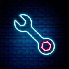 Glowing neon line Wrench spanner icon isolated on brick wall background. Colorful outline concept. Vector