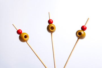Isolated olives on skewers with white background