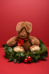 christmas teddy bear Rabbit with floppy ears isolated on a red backgound