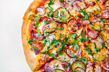 Fresh pizza pickles, bacon, sausages and cheese on a wooden board. Close-up, selective focus