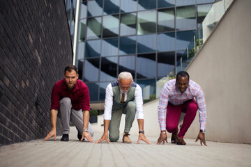 Three business men outside preparing for rice.