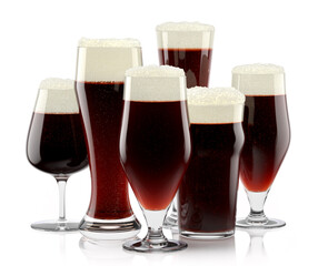 Set of fresh stout beer glasses with bubble froth isolated on white background.