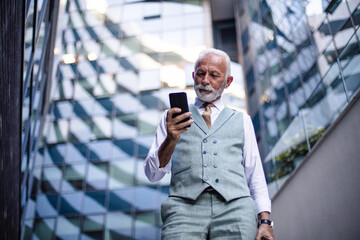 Senior business man talking on smart phone.