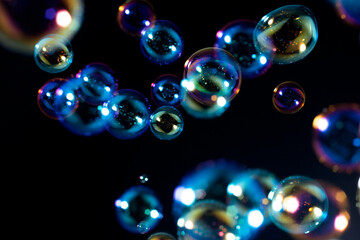 Beautiful Blurred Colorful Soap Bubbles Float on Black Background.
