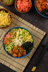 Hawaiian salmon poke bowl with seaweed, avocado, sesame seeds.