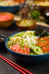 Hawaiian salmon poke bowl with seaweed, avocado, sesame seeds.