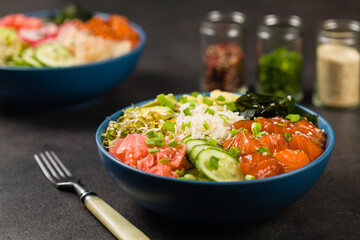 Hawaiian salmon poke bowl with seaweed, avocado, sesame seeds.