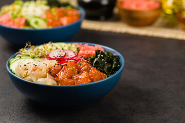 Hawaiian salmon poke bowl with seaweed, avocado, sesame seeds.