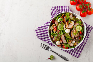 Salad with pork tenderloin, fresh cucumber and mozzarella.