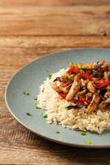 Pork chop with peppers, mushrooms and bamboo. Served with rice.