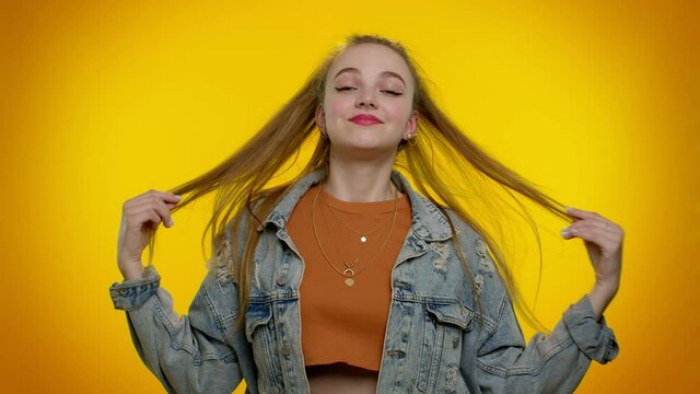 I am the best. Proud egoistic stylish girl in denim jacket proud of her victory, bragging own success win achievements, pointing with smile fingers on herself. Young woman on yellow studio background