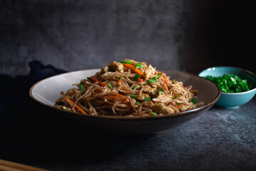 Chinese noodles with egg, carrots and spring onions