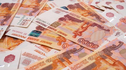 Five thousandth bills of a Russian bank as a background.
