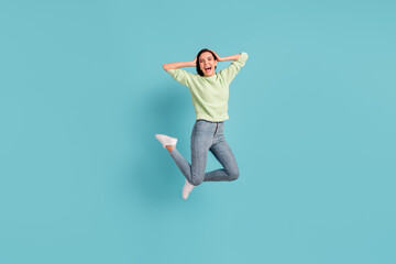 Fototapeta na wymiar Full length portrait of impressed cheerful girl hands on head open mouth isolated on blue color background
