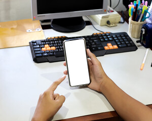 A smartphone with a creative white screen and a field of electric wind turbines in the background.	