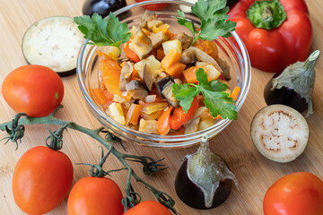 vegetables raw and cooked on a wooden board