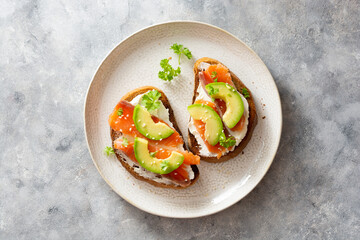 Healthy food, avocado and red fish salmon toast sandwich for breakfast or keto dieting
