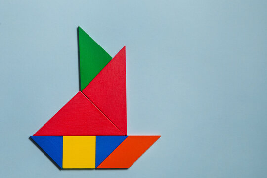 Ship of colorful tangrams in blu background 