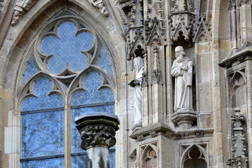 Close-up on statues and ornaments (Dutch Gothic architecture) on the external facade of St Janskathedraal (St John's Cathedral), located in the historical center of Hertogenbosch, Netherlands