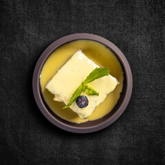 Poppy seeds cake topped with vanilla sauce