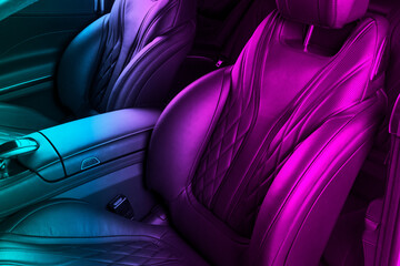 Modern Luxury car inside. Interior of prestige modern car in blue and pink tones. Comfortable leather seats. Perforated leather. Modern car interior. Car inside