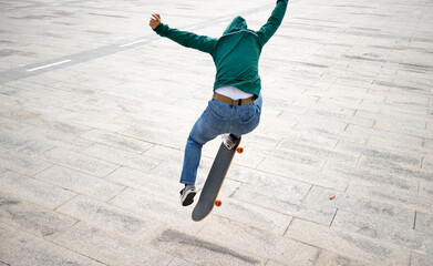 Asian woman skateboarder skateboarding in modern city