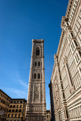 The side facade of the Florence Cathedral, Duomo of Santa Maria del Fiore and bell tower of Giotto di Bondone (Campanile). UNESCO world heritage site, Piazza del Duomo, Tuscany, Italy, Europe.
