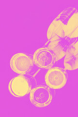 Wine glasses with shadows, duotone gradient yellow and pink. Abstract background.
