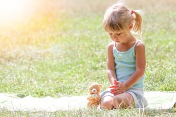 happy little girl praying in nature