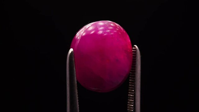 natural red rhodolite gemstone on the turning table