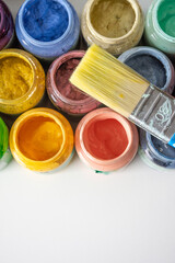 top view of colorful paints and brush