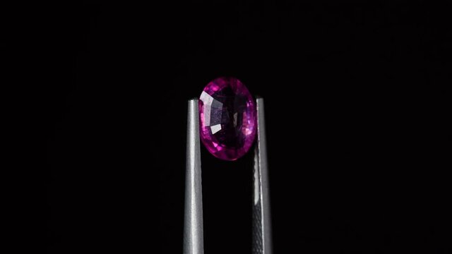 natural red rhodolite gemstone on the turning table