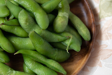 Japanese food edamame nibbles, boiled green soy beans Close up