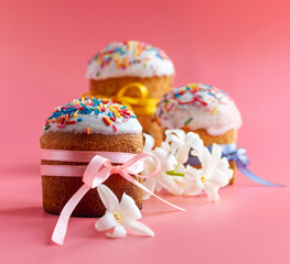Traditional Easter cakes and Hyacinthus flowers on pink background with copy space for text. Traditional Kulich, Paska Easter Bread. Postcard