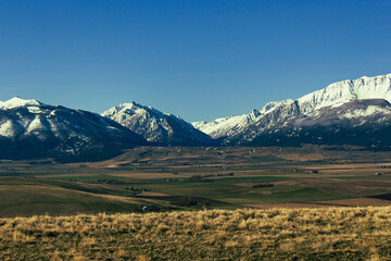 Scenic shot of beautiful landscape field below the snowy Wallowa Mountains in Joseph, Oregon