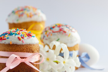 Traditional Easter cakes and Hyacinthus flowers on white background with copy space for text. Traditional Kulich, Paska Easter Bread. Postcard