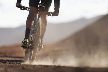 Mountain biker riding on bike singletrack trail, back view of mountain biker. Mountain bike race