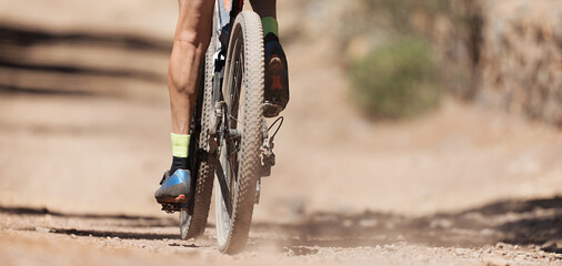 Mountain biker riding on bike singletrack trail, back view of mountain biker. Mountain bike race