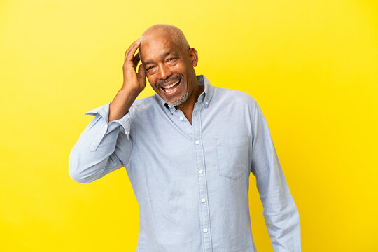 Cuban Senior isolated on yellow background smiling a lot