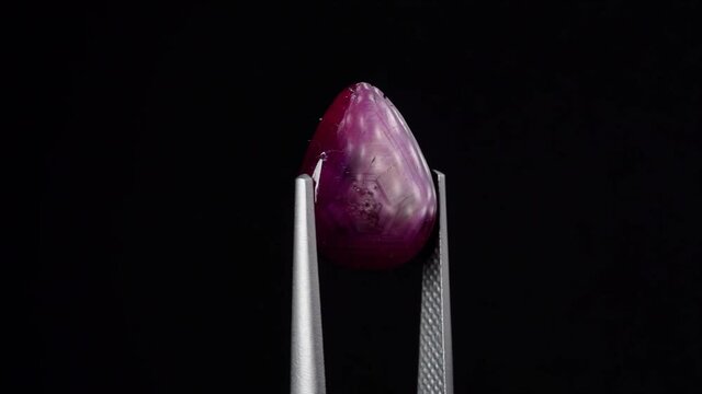 natural red rhodolite gemstone on the turning table