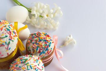 Traditional Easter cakes and Hyacinthus flowers on white background with copy space for text. Traditional Kulich, Paska Easter Bread. Postcard