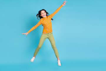 Full body portrait of little lady falling hands sides open mouth have good mood isolated on blue color background