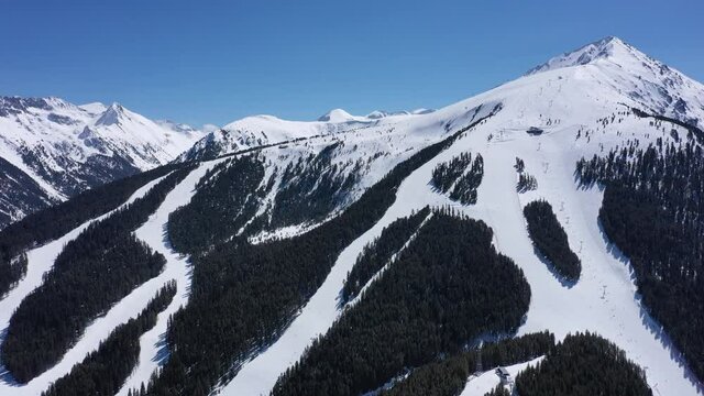 Balkans, Todorka mountain peak, ski tracks, covered with snow. Beautiful alpine natural winter backdrop. Pirin ice top of the hill on the blue sky background.
