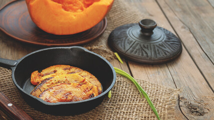 Grilled pumpkin slices. Pumpkin slices served in a frying pan, close-up