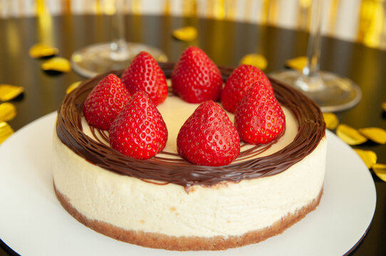 Strawberry cheesecake. Festive mood. Black and gold decoration. party, enjoyment, pleasure concept
