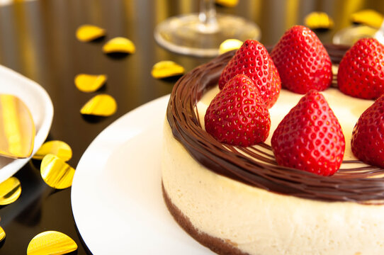 Strawberry cheesecake. Festive mood. Black and gold decoration. party, enjoyment, pleasure concept
